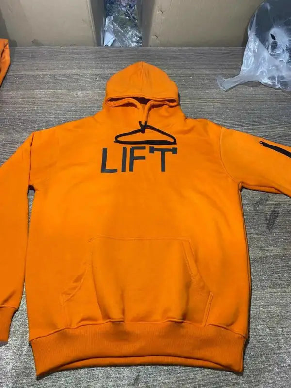 Bright orange hooded sweatshirt with ’LIFT’ printed on the chest.
