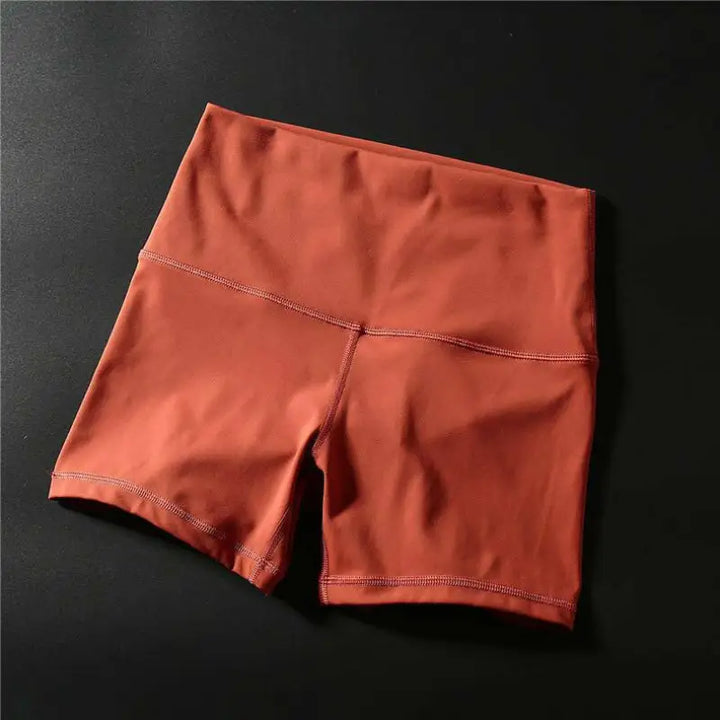 Pair of rust-colored athletic shorts or compression shorts.