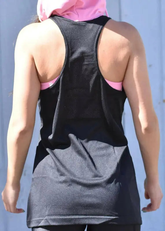 Black racerback athletic tank top worn over a pink sports bra.