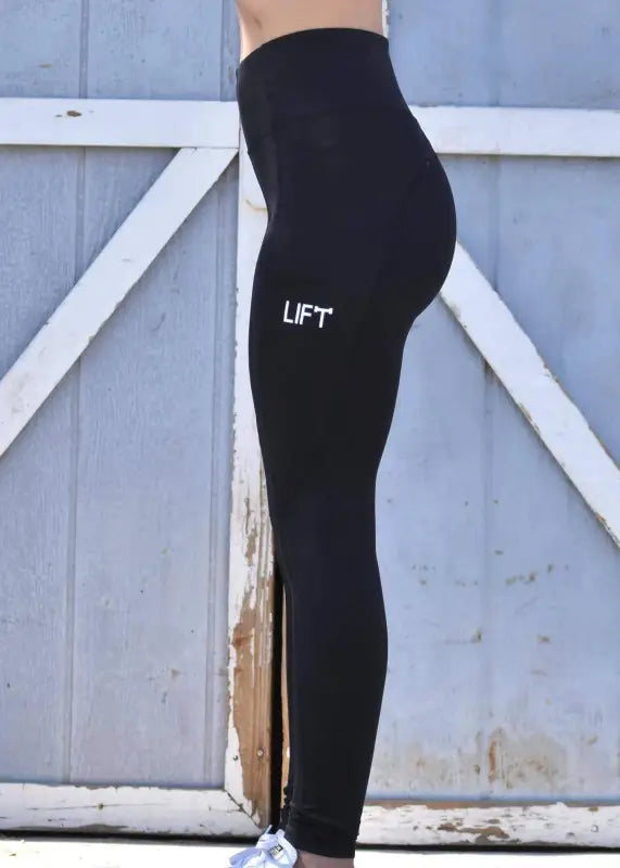 Black leggings with ’LIFT’ printed on the side.
