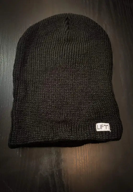 Dark gray knit beanie with a small white ’LIFT’ tag.