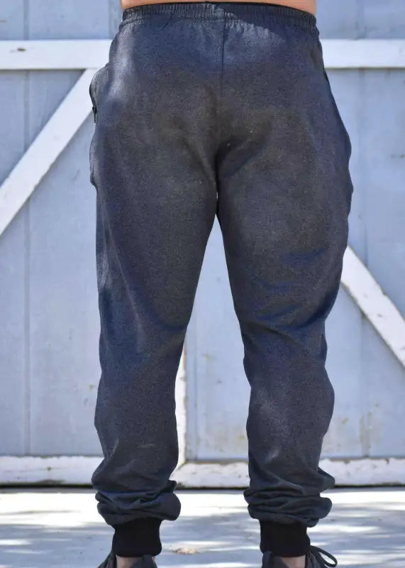 Gray sweatpants or joggers with an elastic waistband and cuffed ankles.