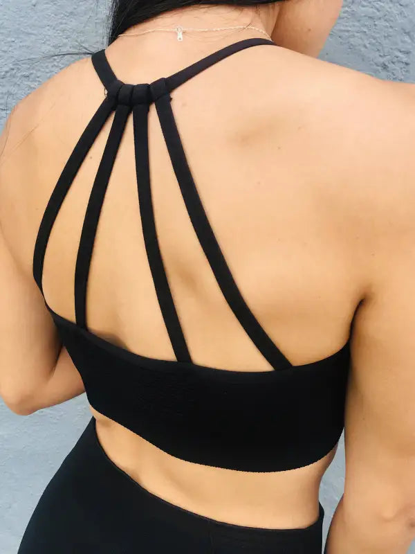 Black sports bra with strappy back design.